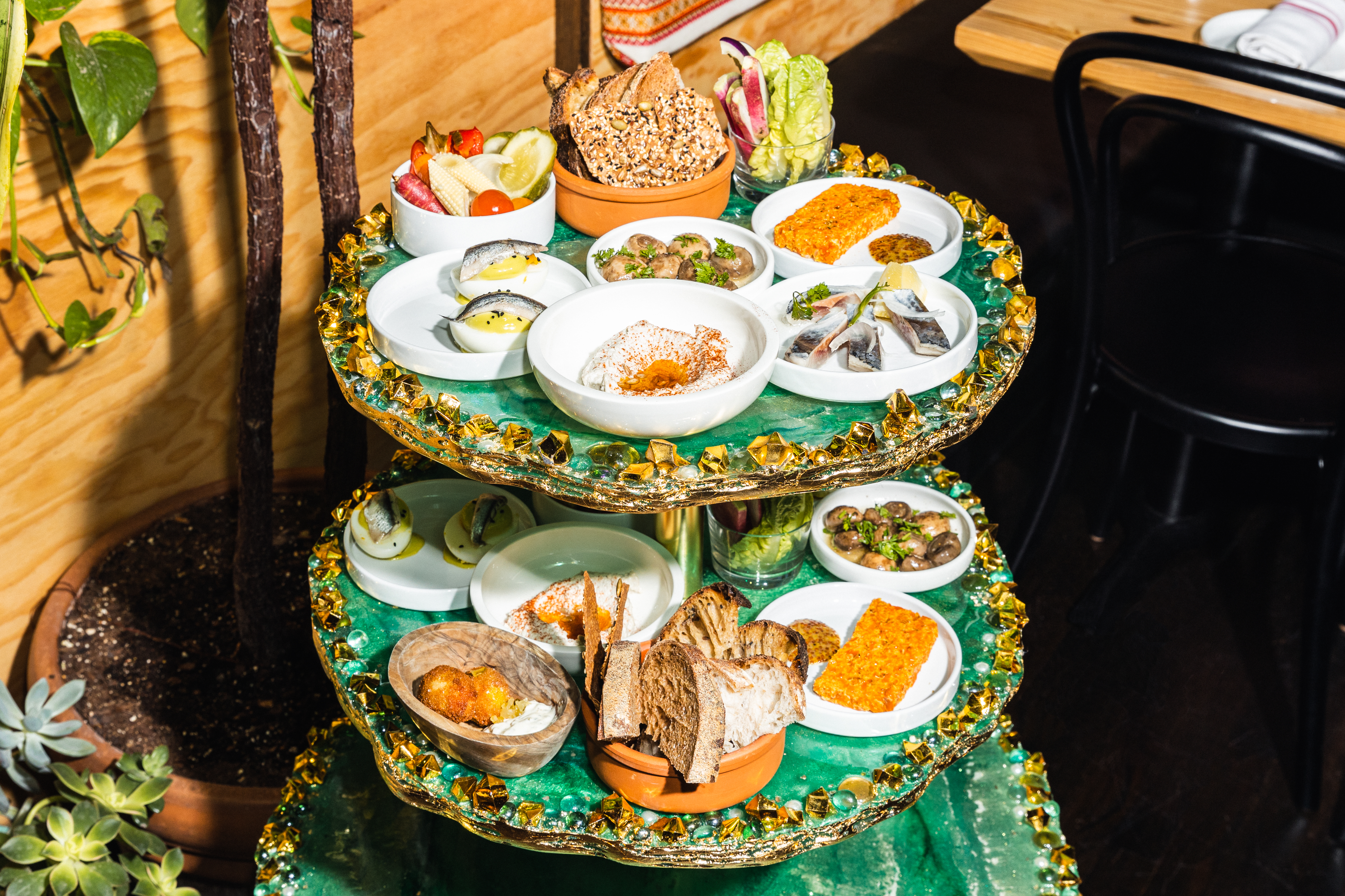 A tiered tray of small Ukrainian dishes.