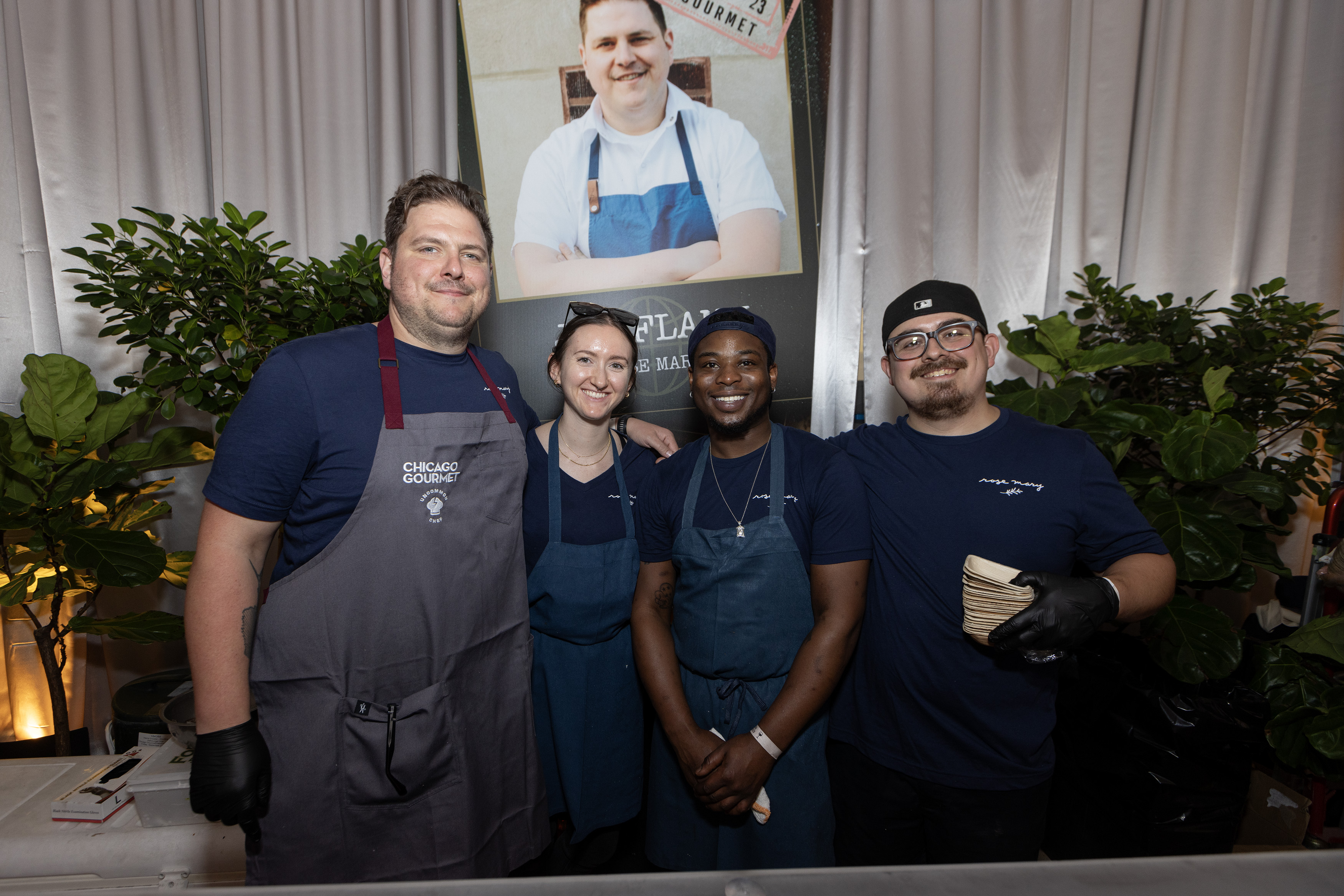 A group of four folks in aprons posing, including Joe Flamm on the left.