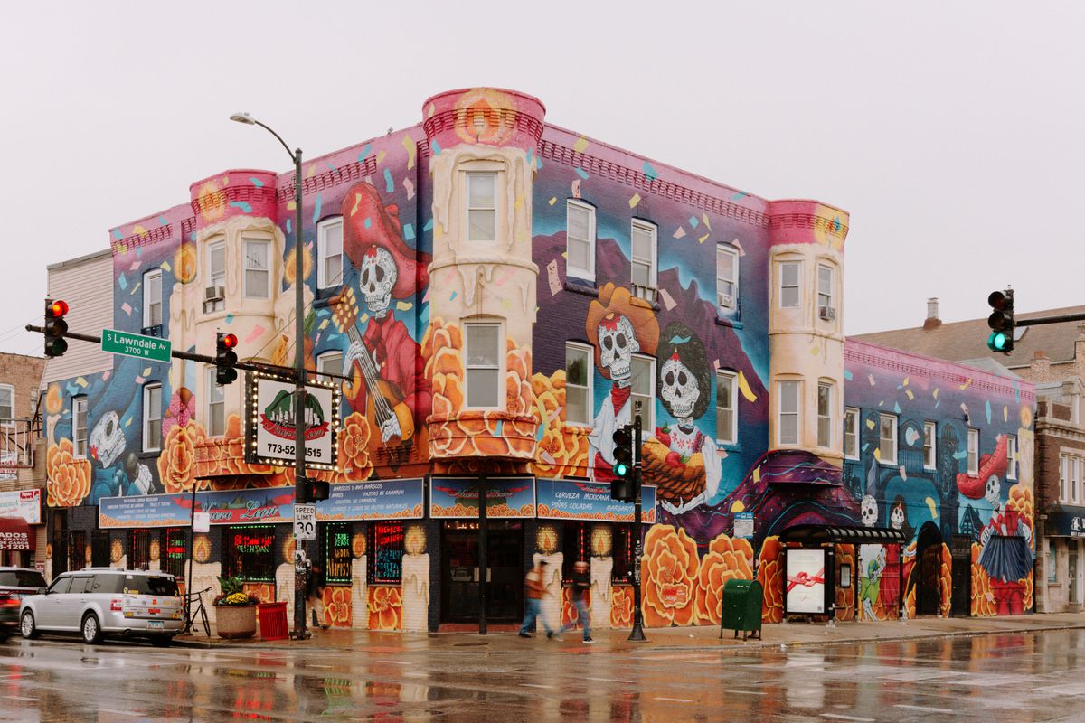 Nuevo Leon Restaurant, covered in Mexican American murals, on a street corner.