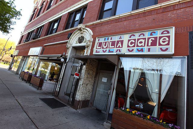 A brick building with a sign that reads “Lula Cafe.”  